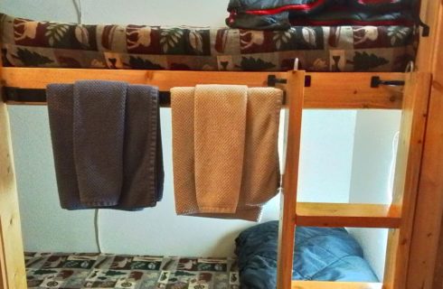 Bunk Beds with sleeping bags and towels.