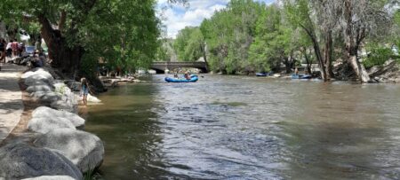 Summer day with raft floating on the river.