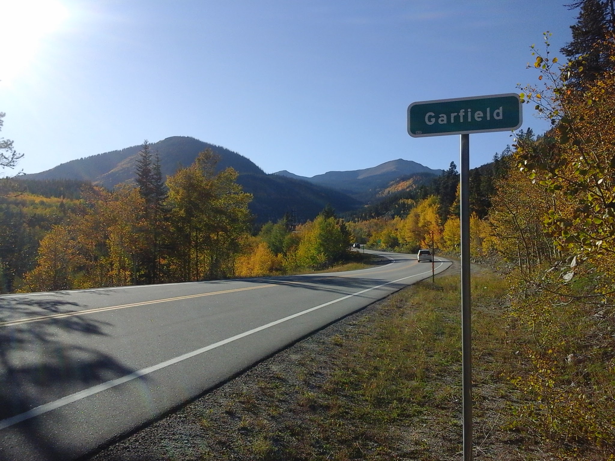 Beautiful fall day with sunshine along Monarch Pass, next to the Garfield highway sign.