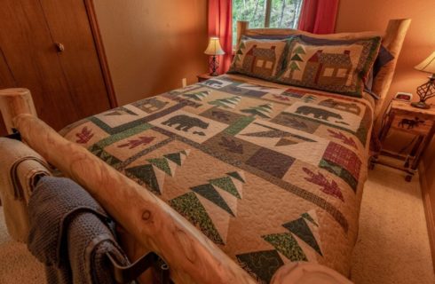 Guest bedroom with a full size log bed.
