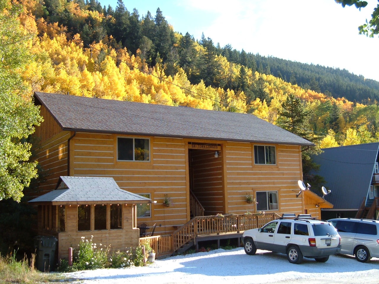 Sunny fall day, autumn gold log sided condos with mountain views all around.