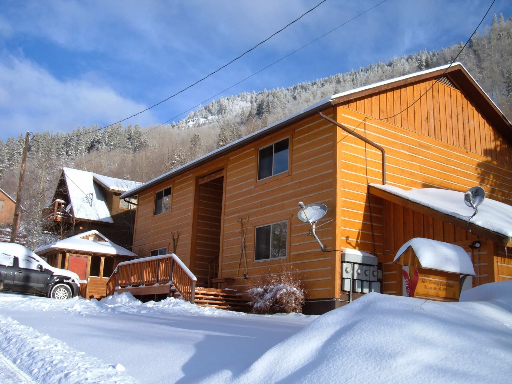 Winter with snow all around a 4-plex in the mountains.