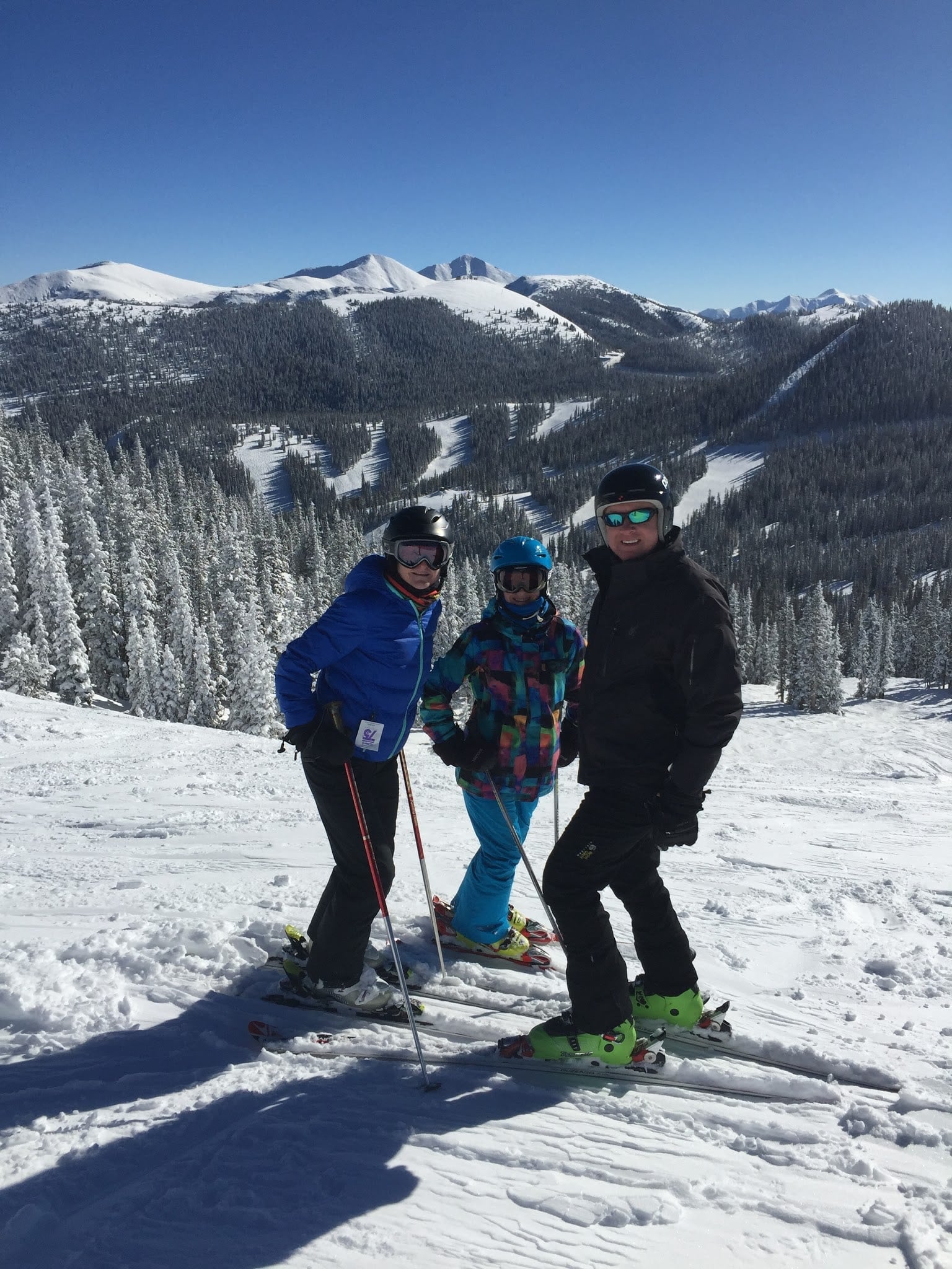A family skiing on a sunny winter day.