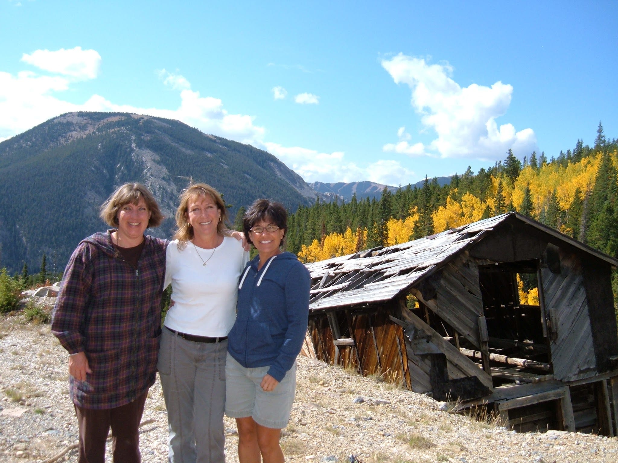 Mountain fall colors with three ladies at a historic mining camp.