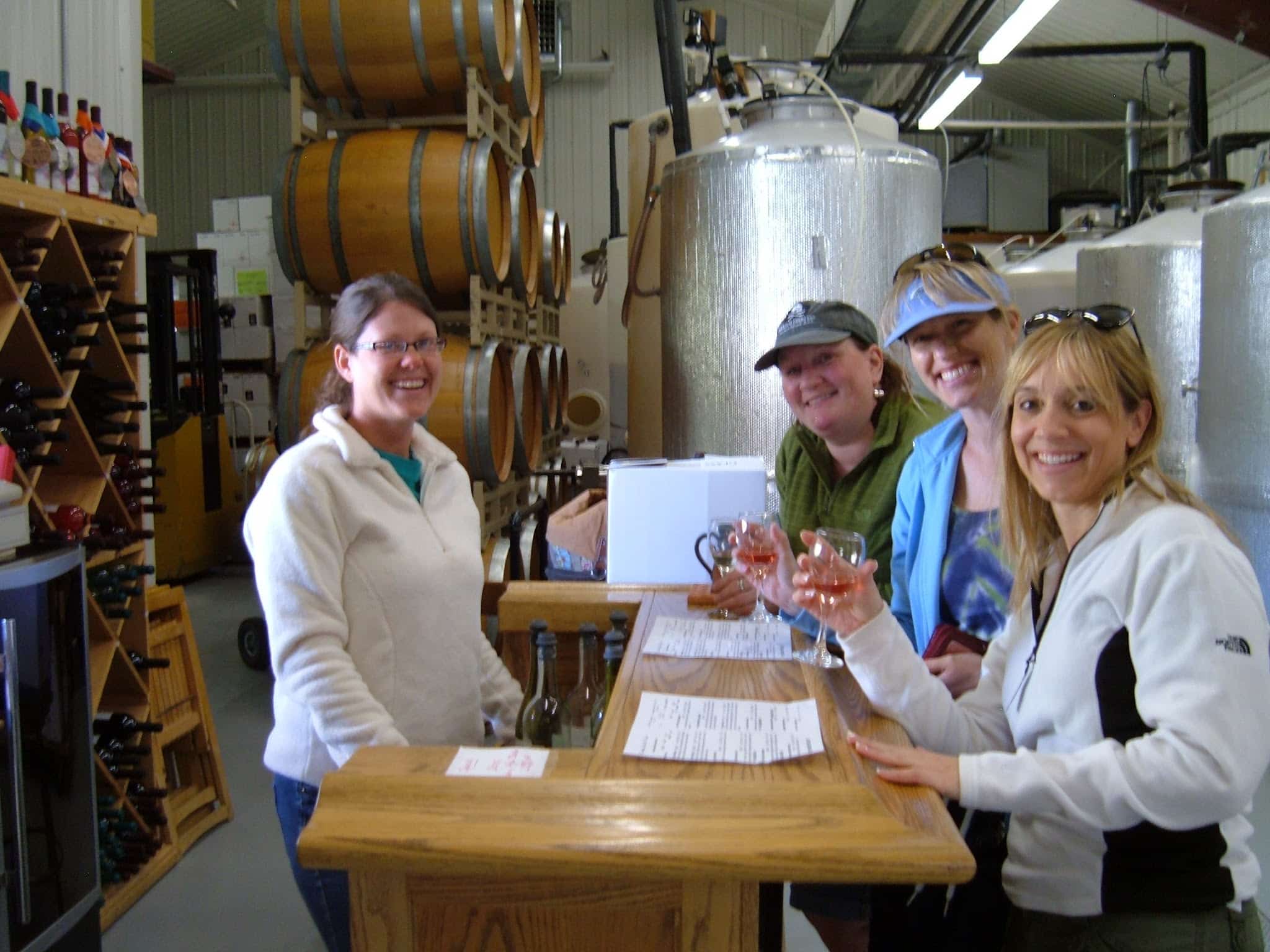 Four ladies at a winery tasting wine.
