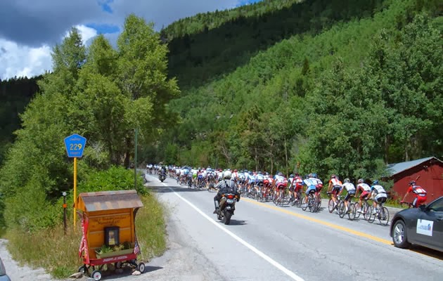 Hundreds of cyclists riding the mountain pass.