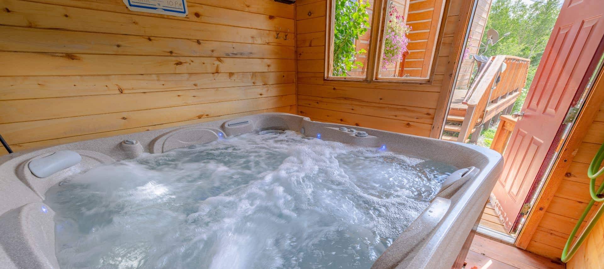 Wooden building housing a hot tub with bubbling water
